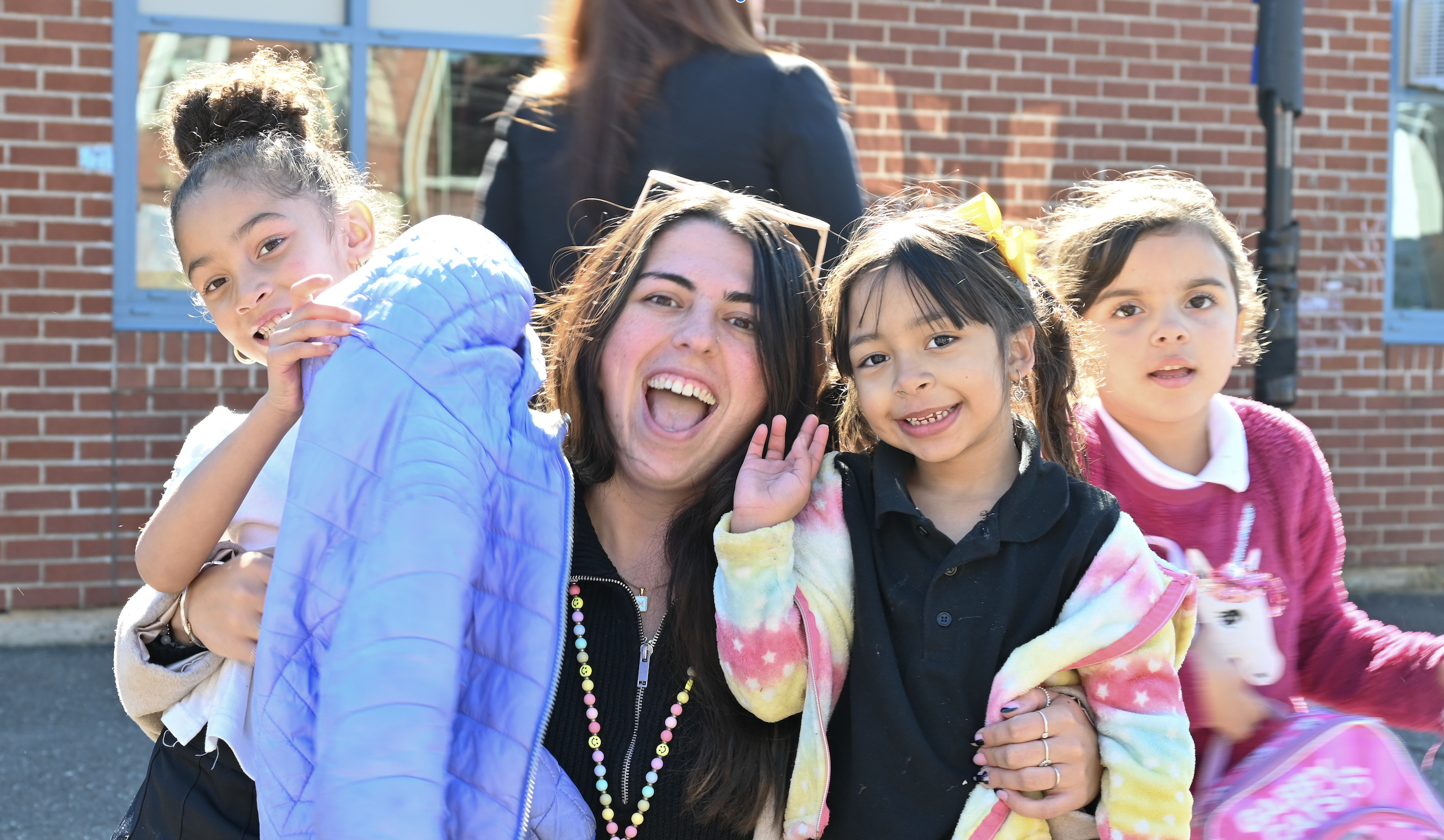 Morgan School teacher Ms. Lutz smiles with some of her students