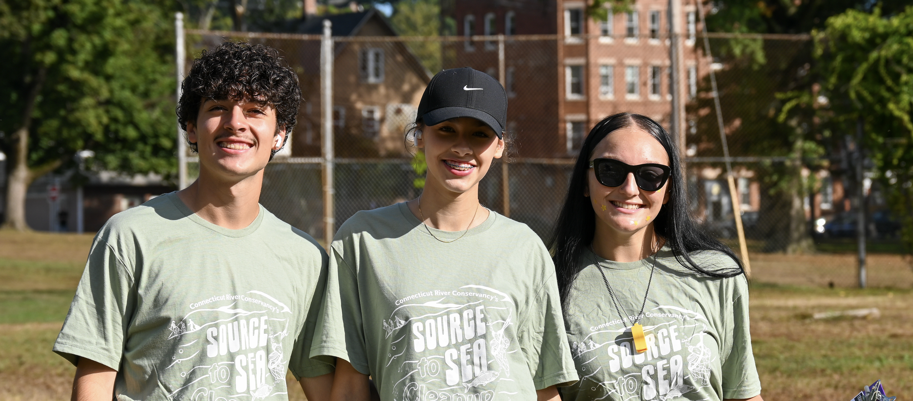 Three students smile at camera in Springdale Park