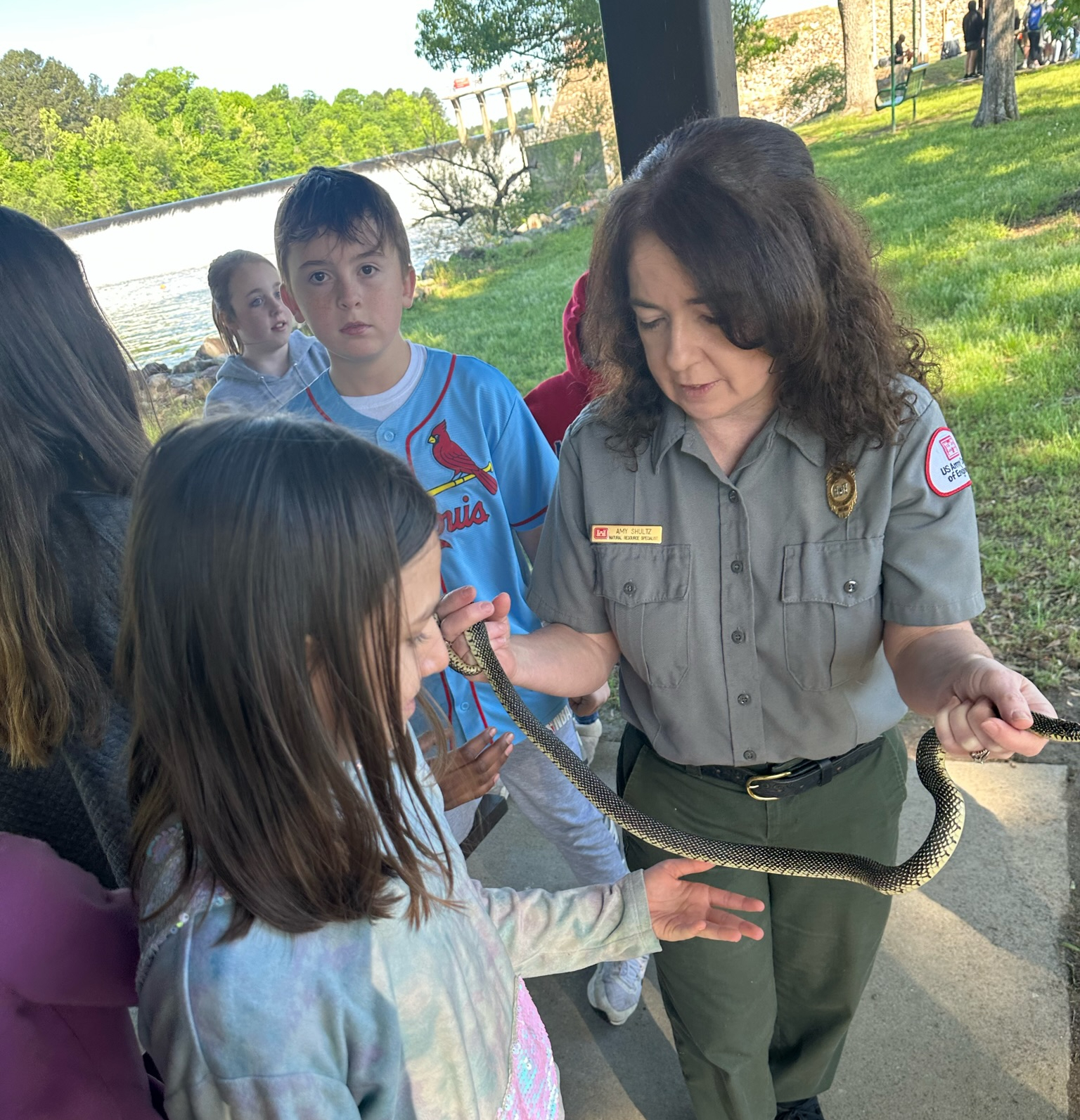 student touching a snake