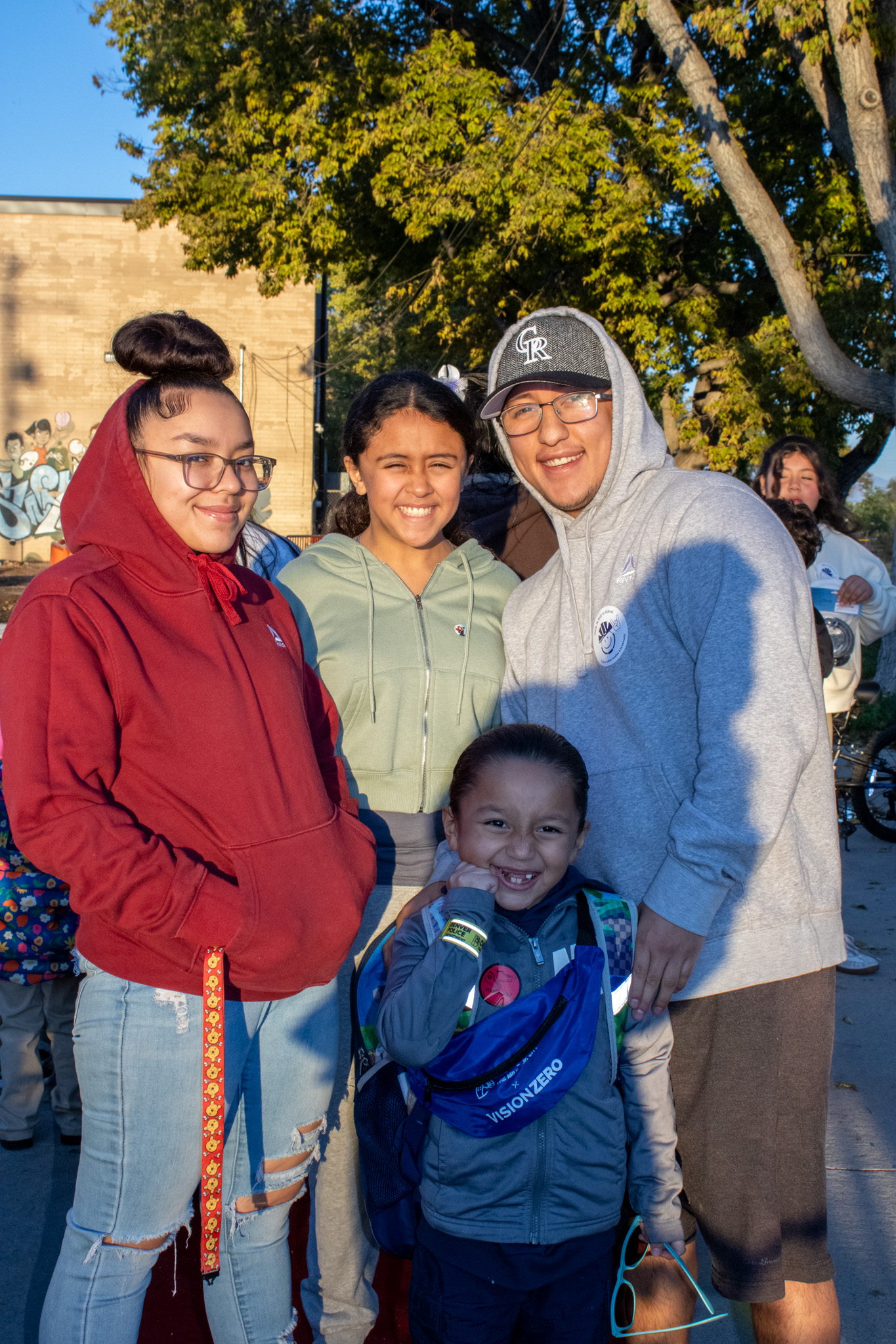 A family smiles for a group photo at the Walk N Roll to school event.