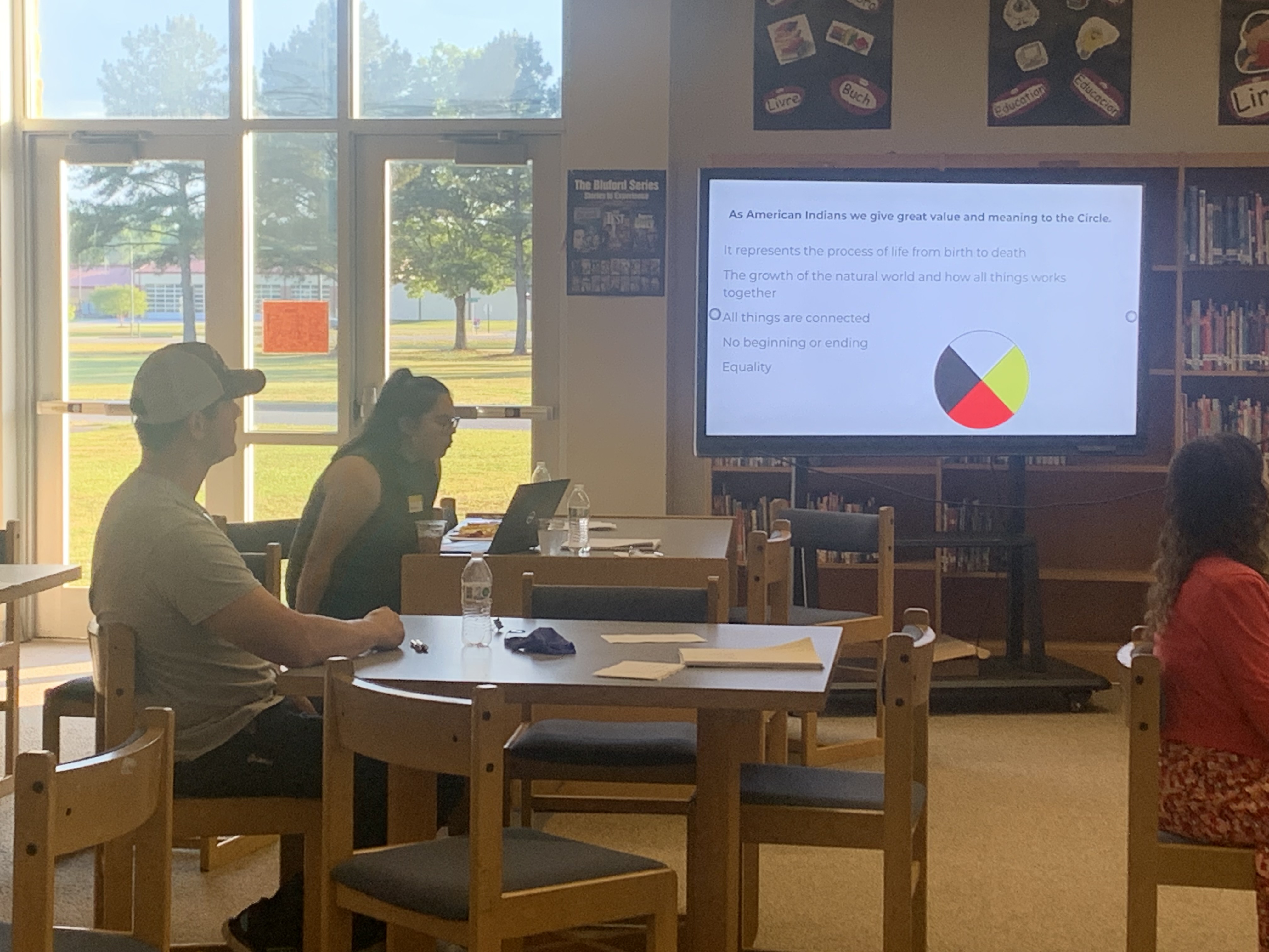 photo of inside a library with two people sitting at a table