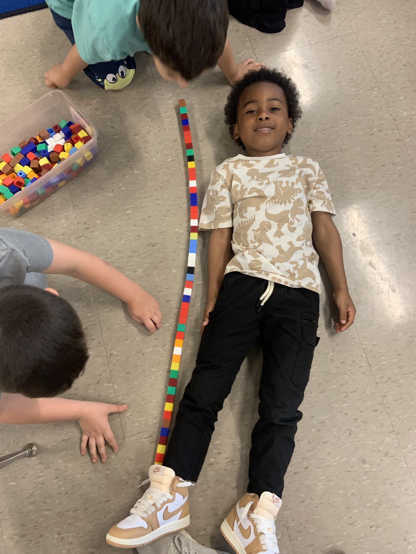 Measuring student's height with cubes