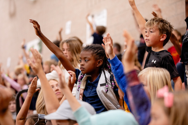 Elementary students raising hands