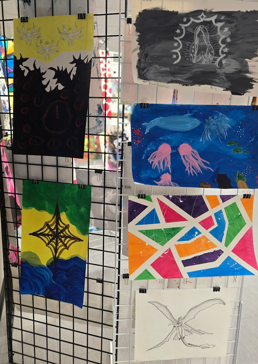colorful student drawings hanging up