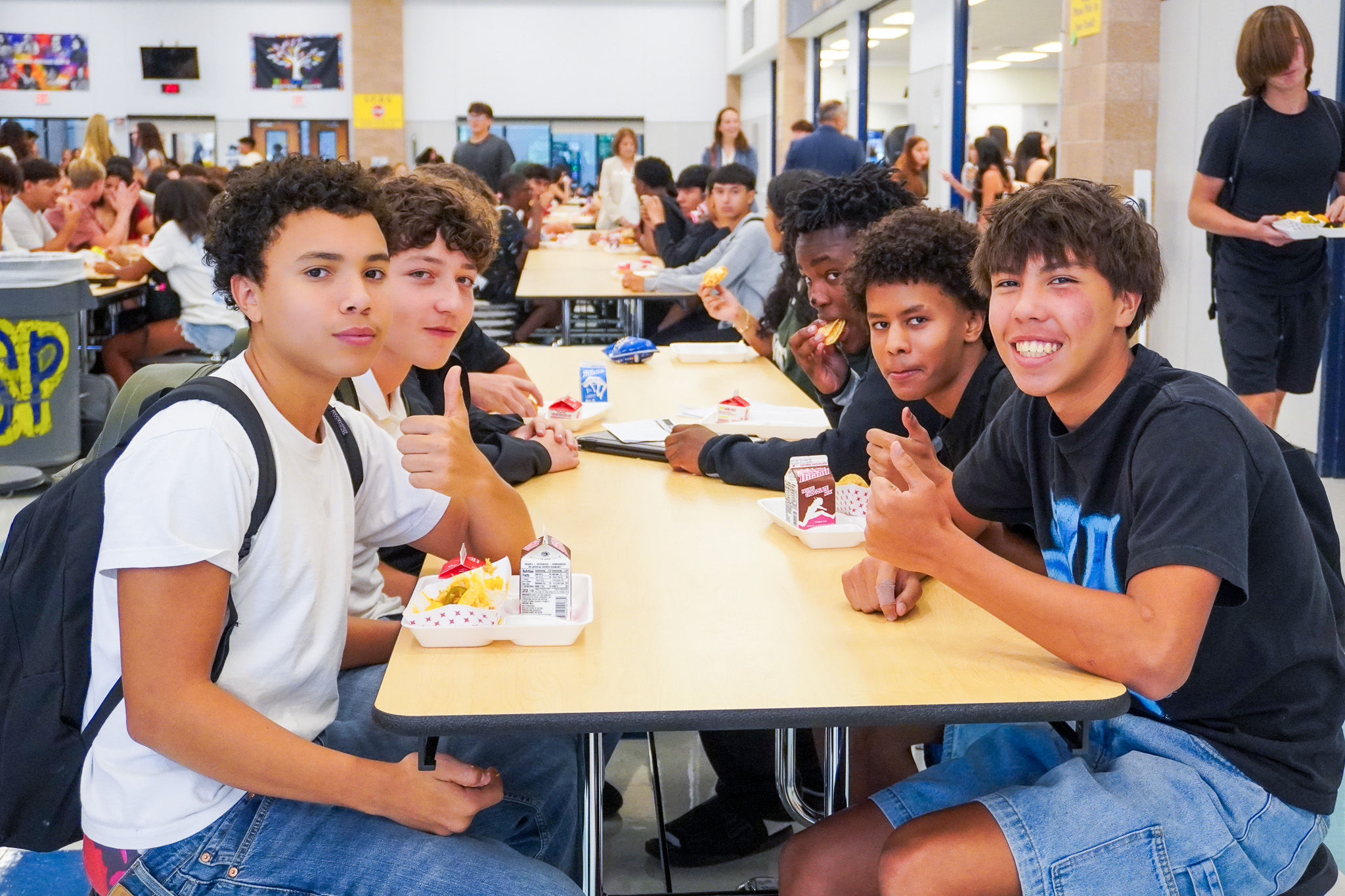 Students sitting at table eating breakfast