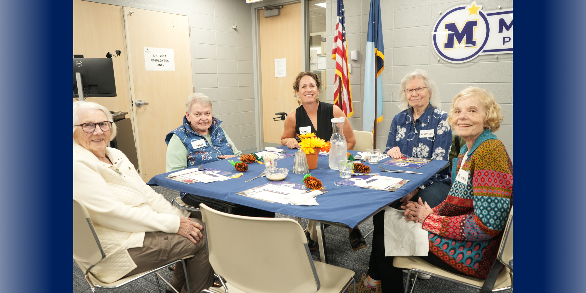 Community members sitting at table during October Community Lunch