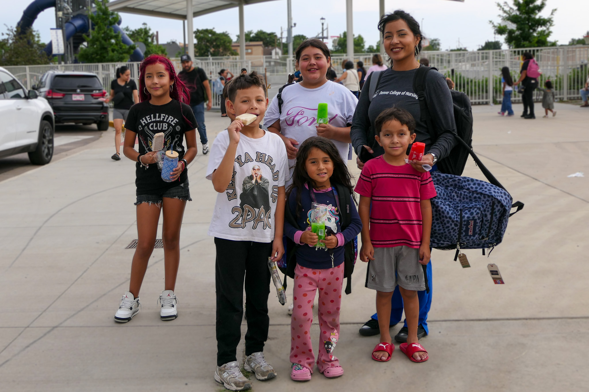 A family poses for a photo while eating a sweet treat at Back to School Night. 