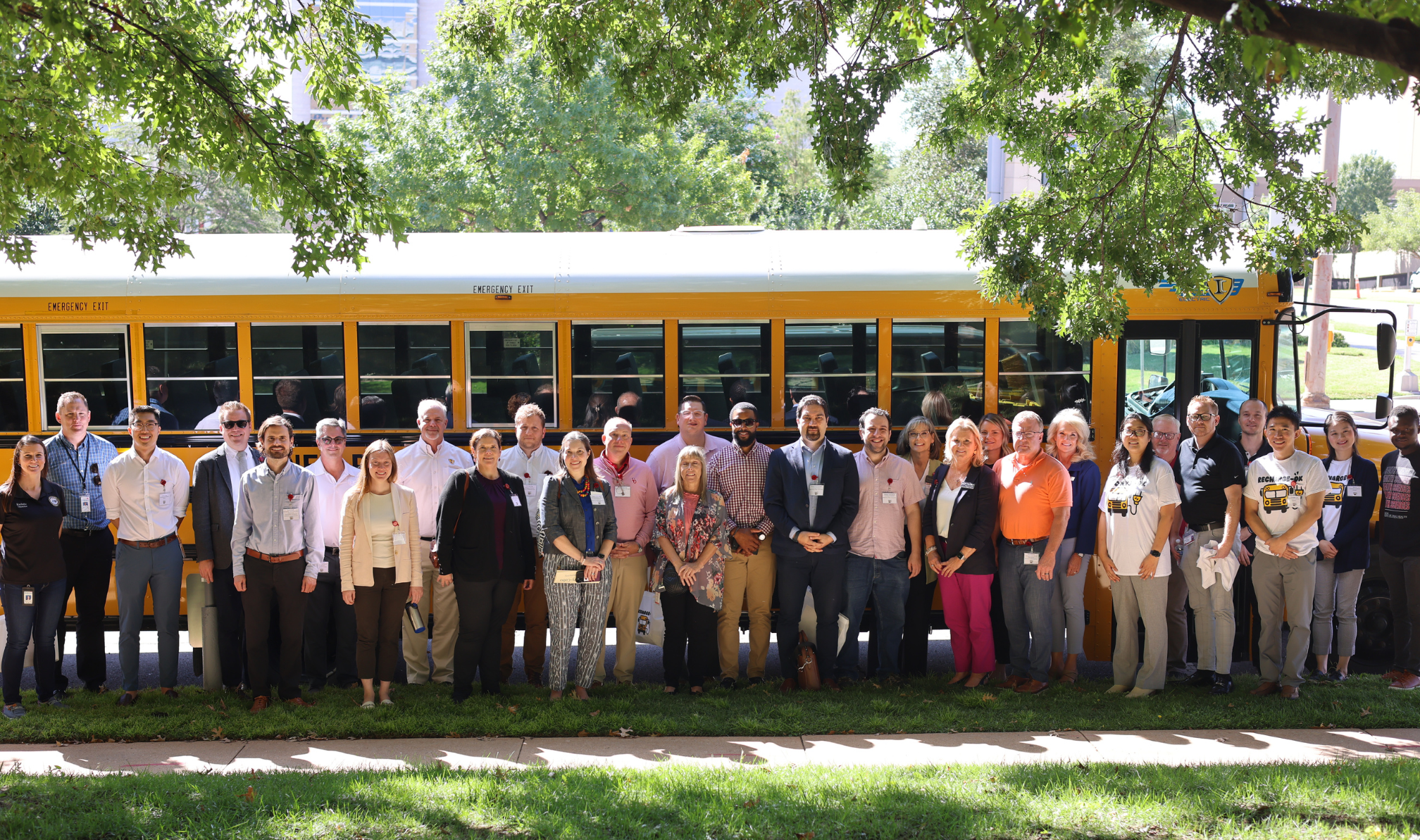 Adults in front of School Bus