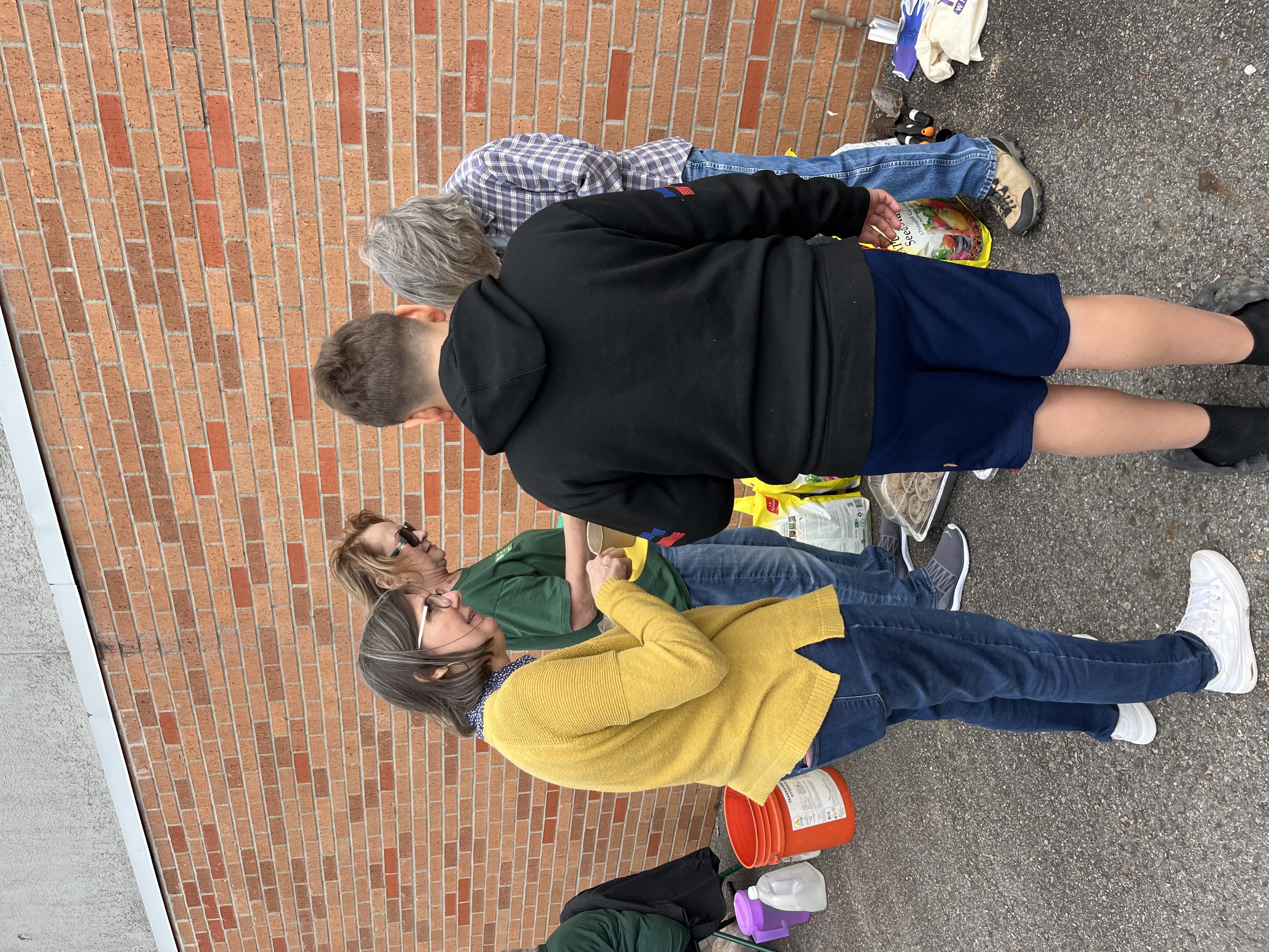 Master Gardeners helping students plant seeds