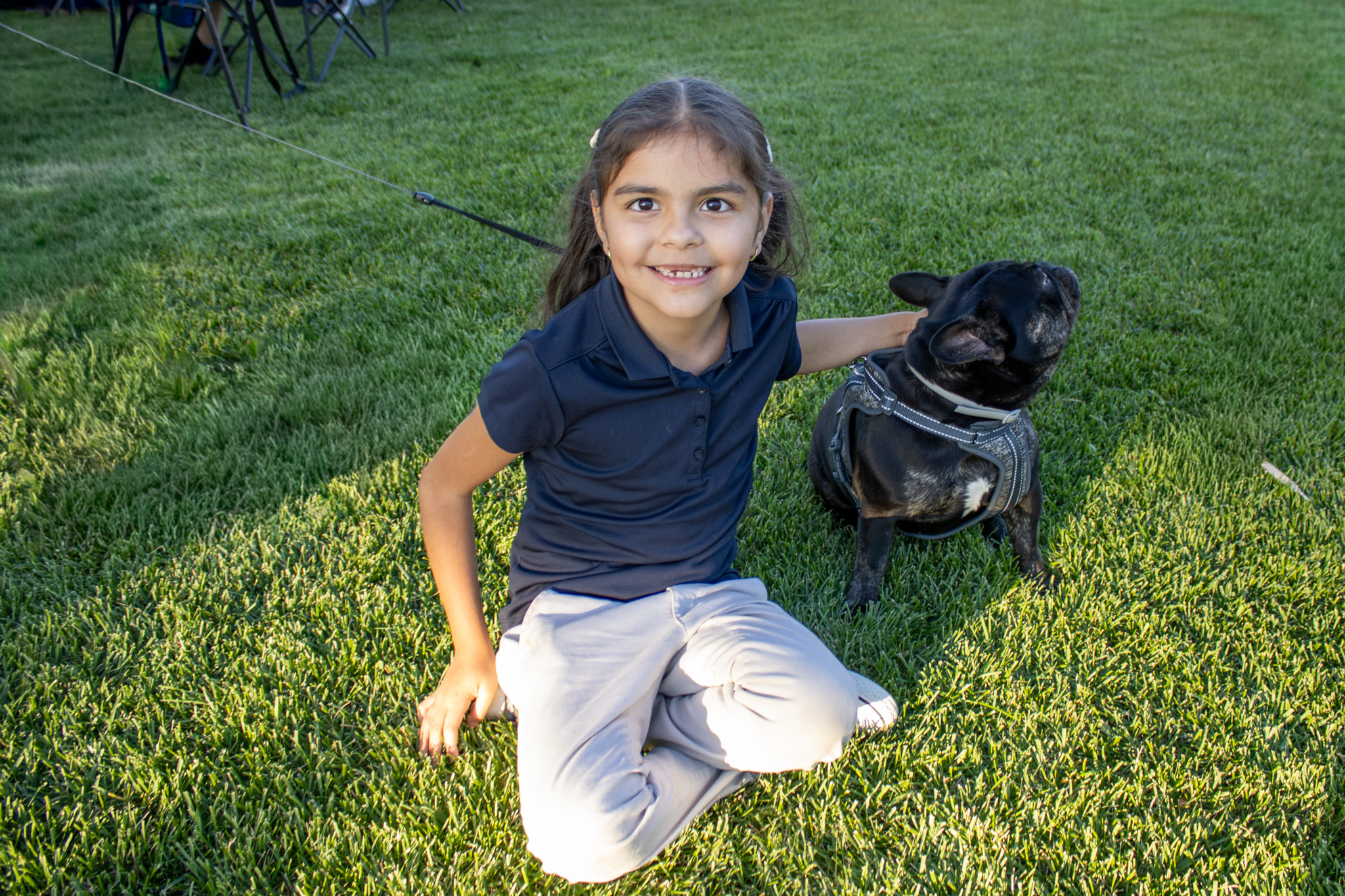 A student poses for a photo with her dog at Fiesta Hispana.