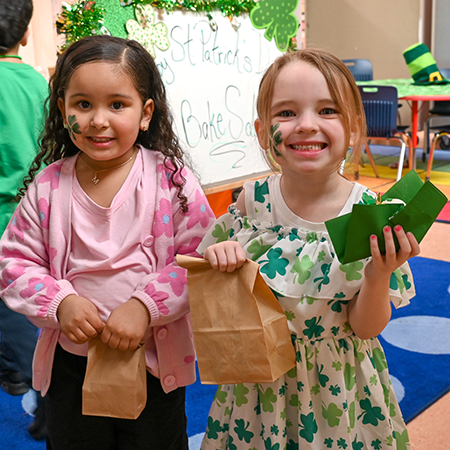 Two students with face paintings of shamrocks