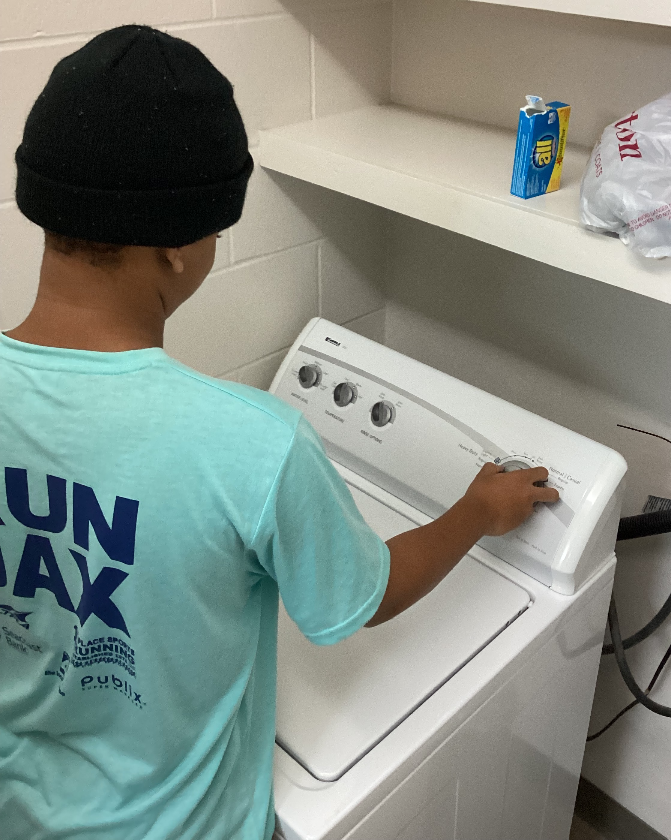 A student in Cary White learns to use the washer.