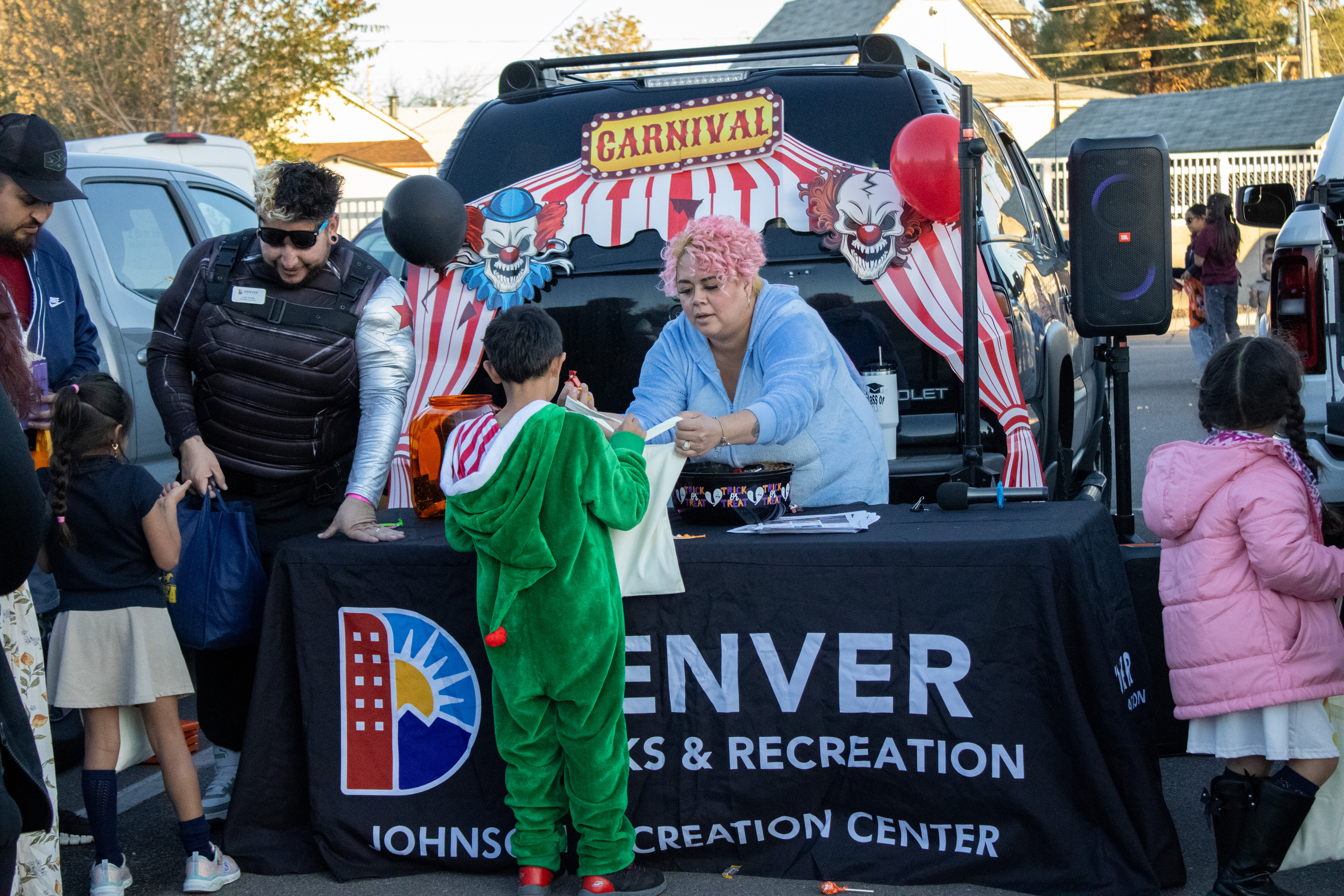 Denver Recreation Center gives students candy at Trunk or Treat. 