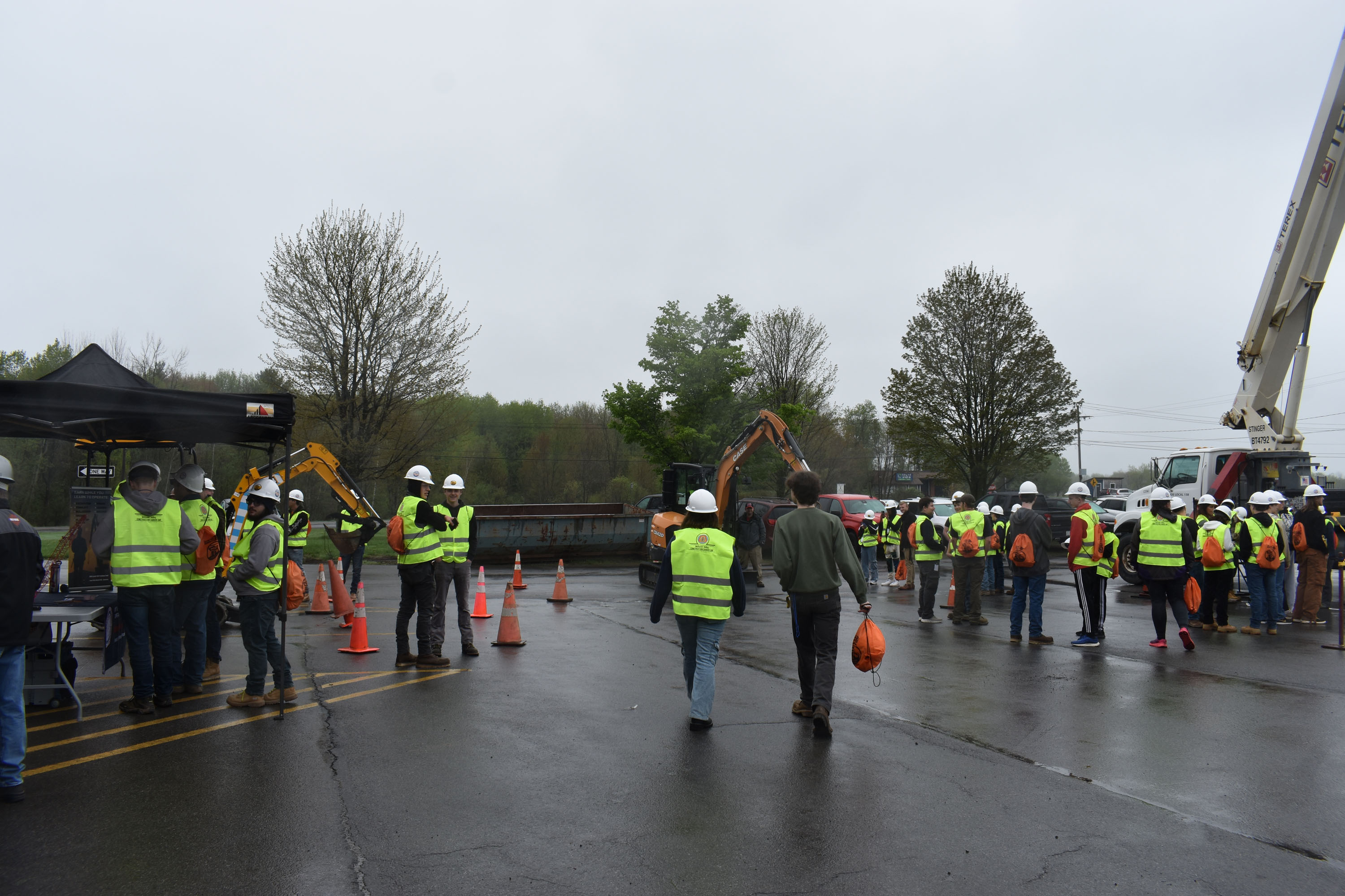 Students, workers and construction equipment outside