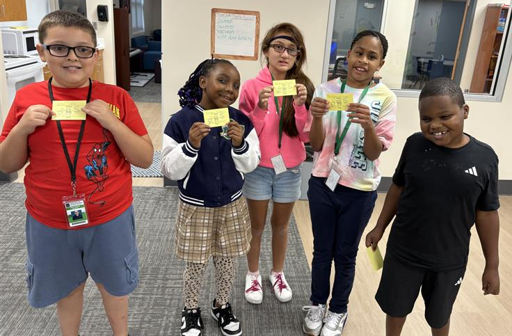 Kramer students holding PBiS tickets.