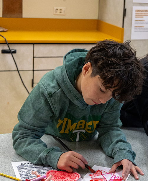 A student paints a dot for Dot Day