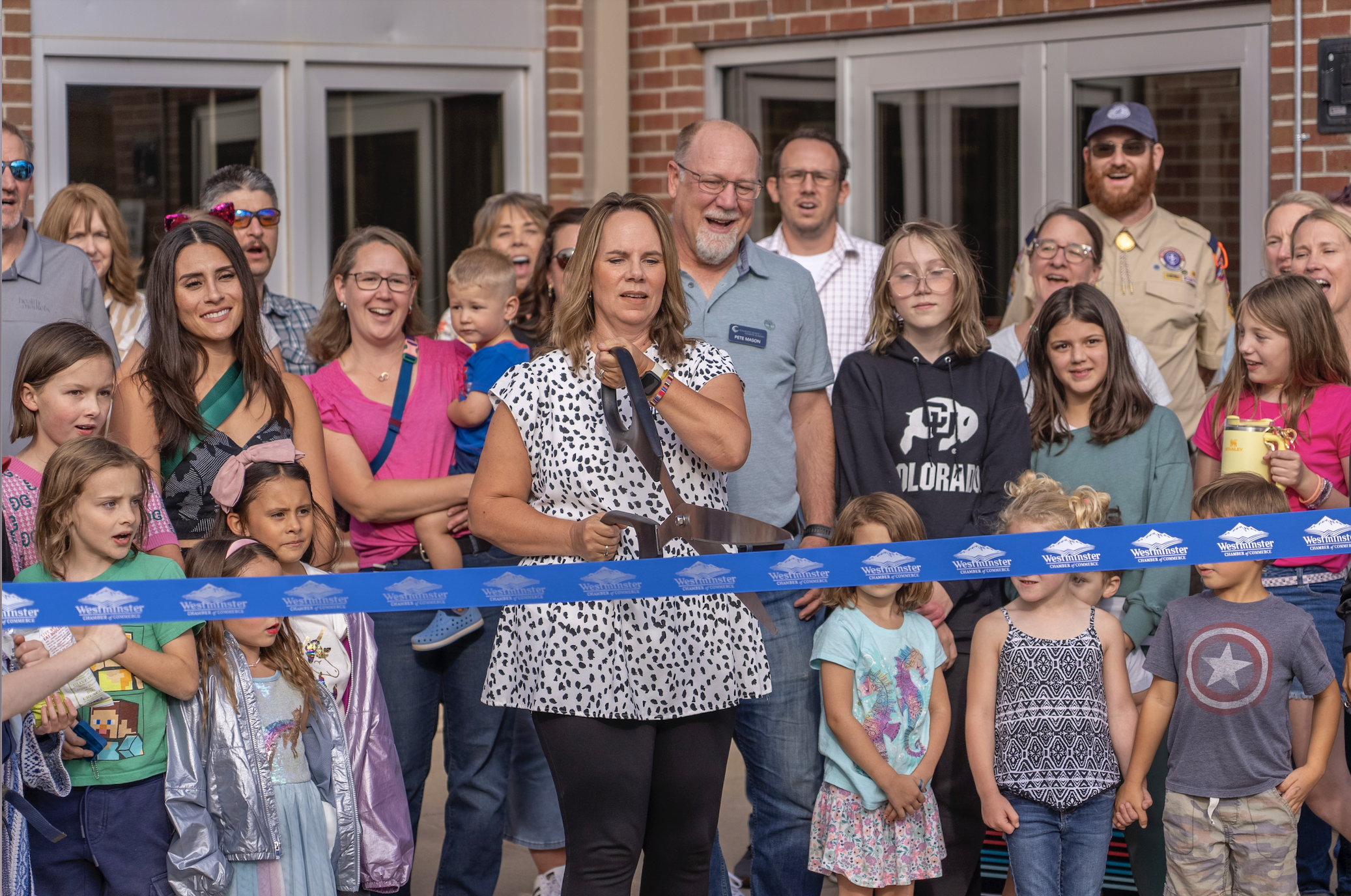 Carrie Mott cutting ribbon in front of JACCC