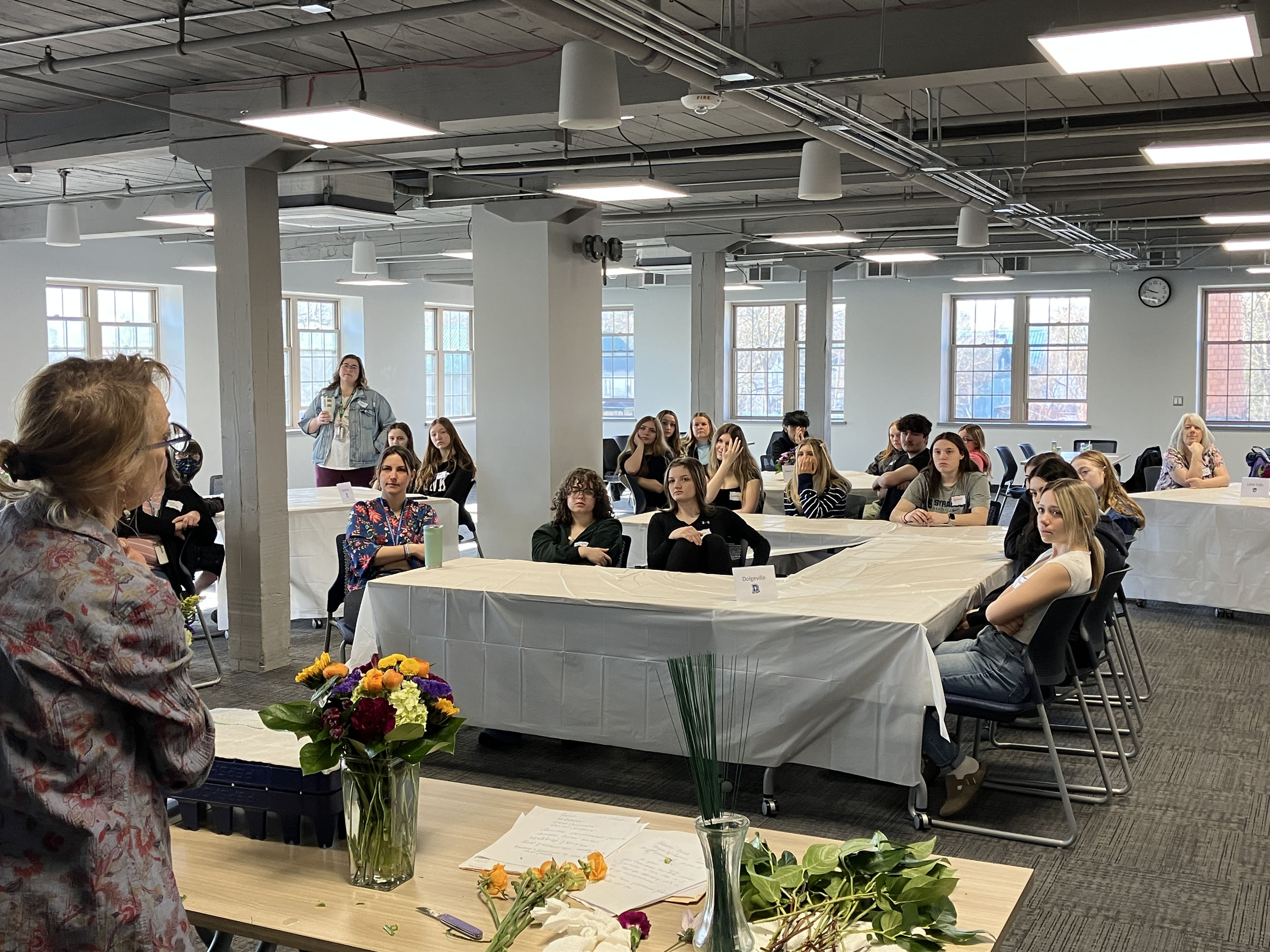 Students look on at floral workshop presenter