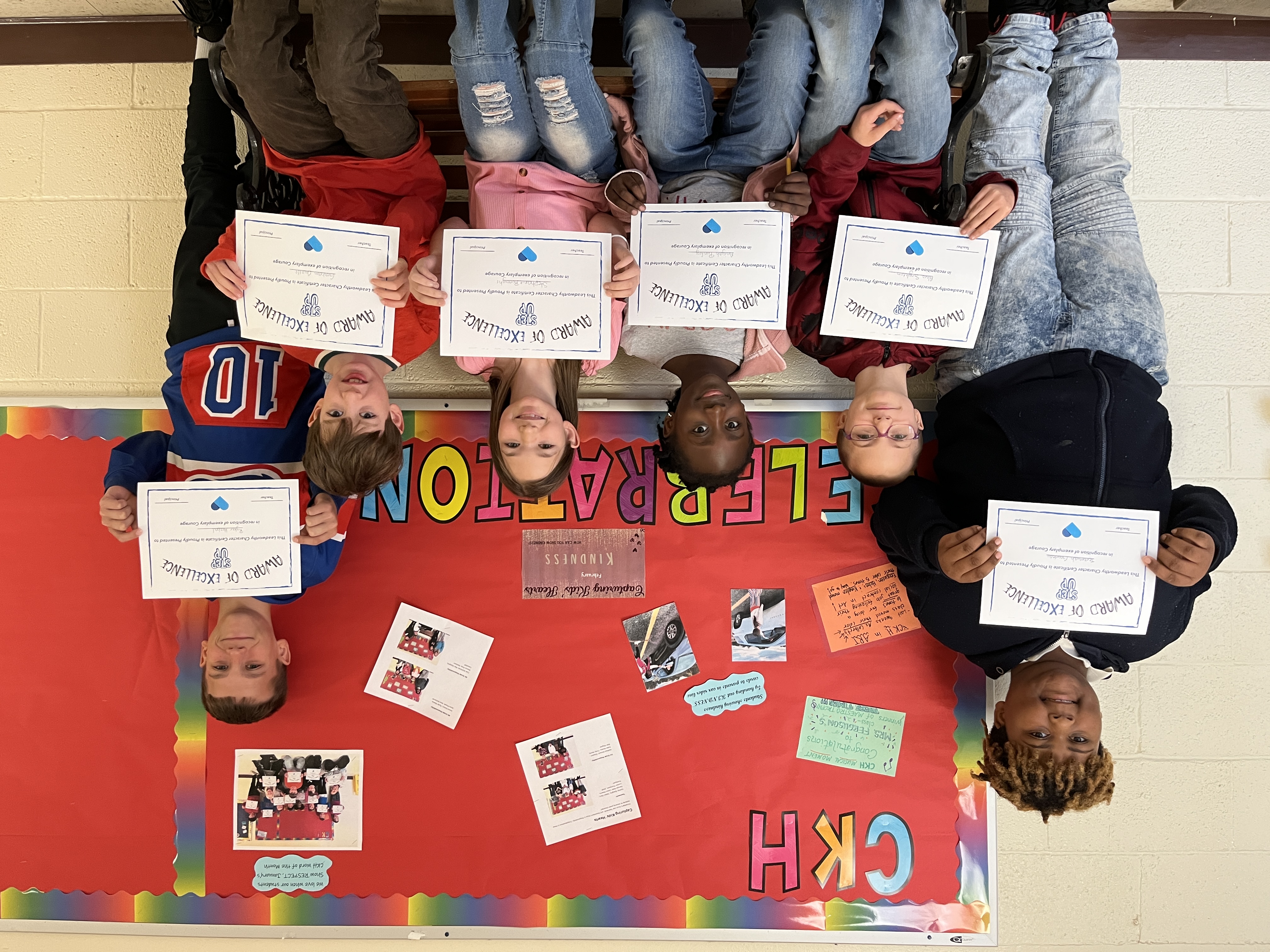 students smiling and holding certificates