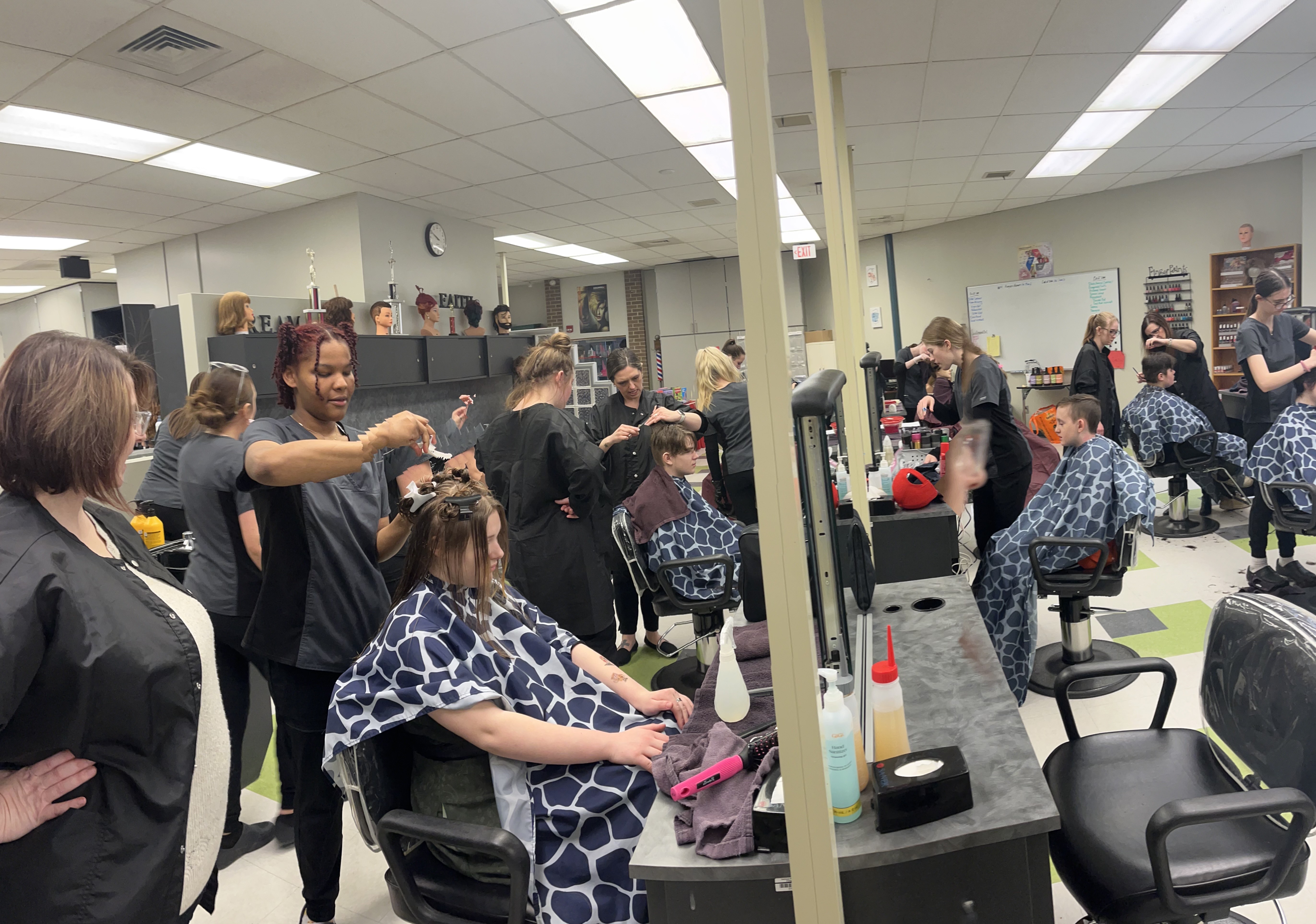 Cosmetology students giving haircuts to Pathways students