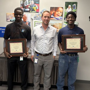 A photo of Kawsu Juwara and Raphael Van Putten, two student interns, with Craig Miller.