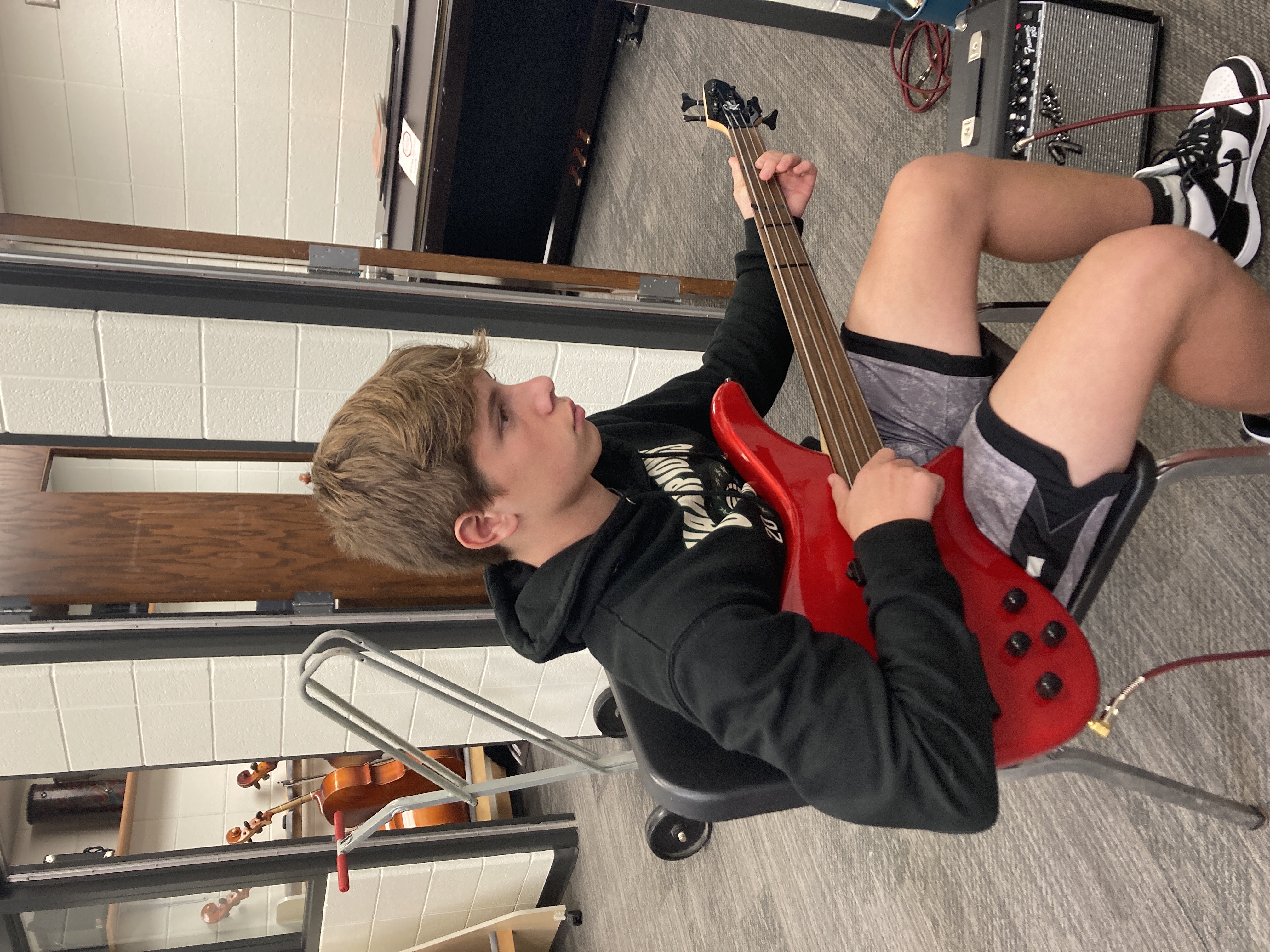 Student playing electric guitar