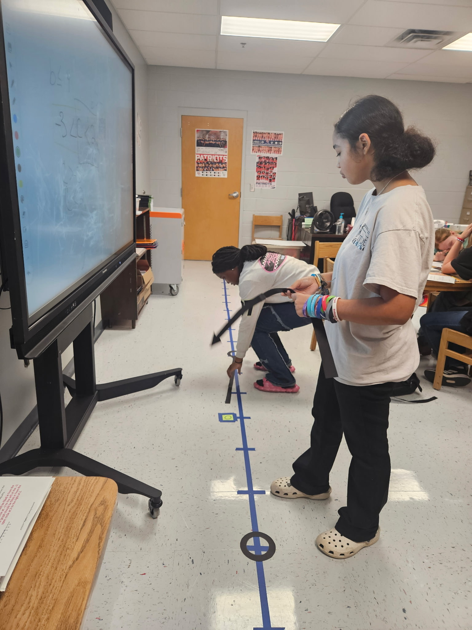 Algebra I students got hands-on with inequalities by graphing them on a number line built right on the classroom floor using painter’s tape. This interactive lesson gave students a chance to literally “walk through” their math learning.