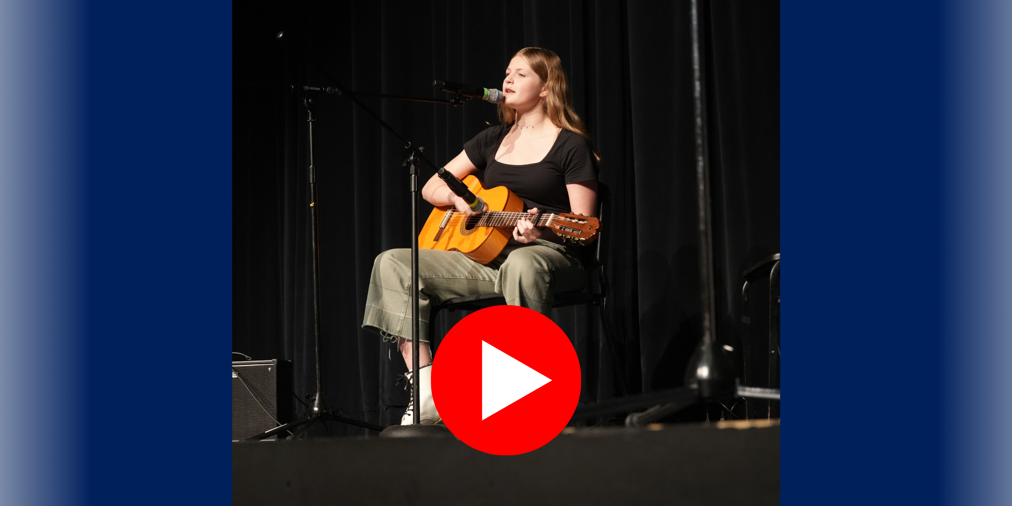 Student playing guitar at recital