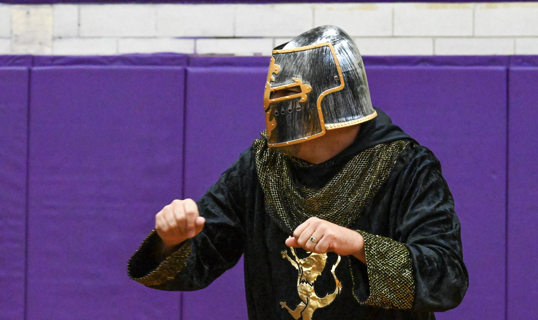 Man dancing at convocation in a Holyoke Knights outfit