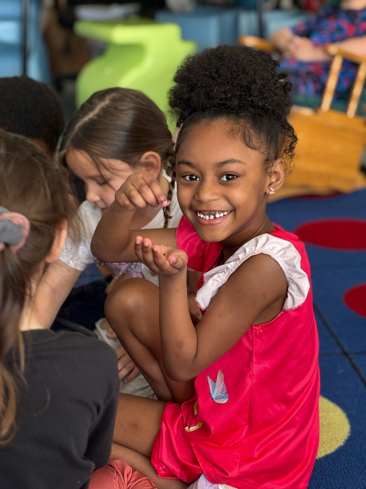 worms in kindergarten - a girl holding a worm