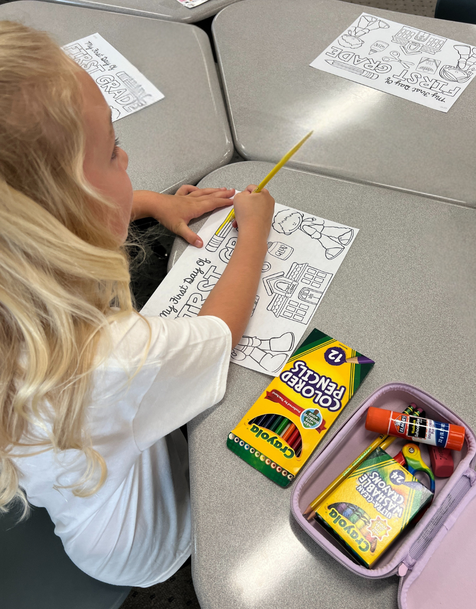 First grader coloring a picture at their desk on the 1st day