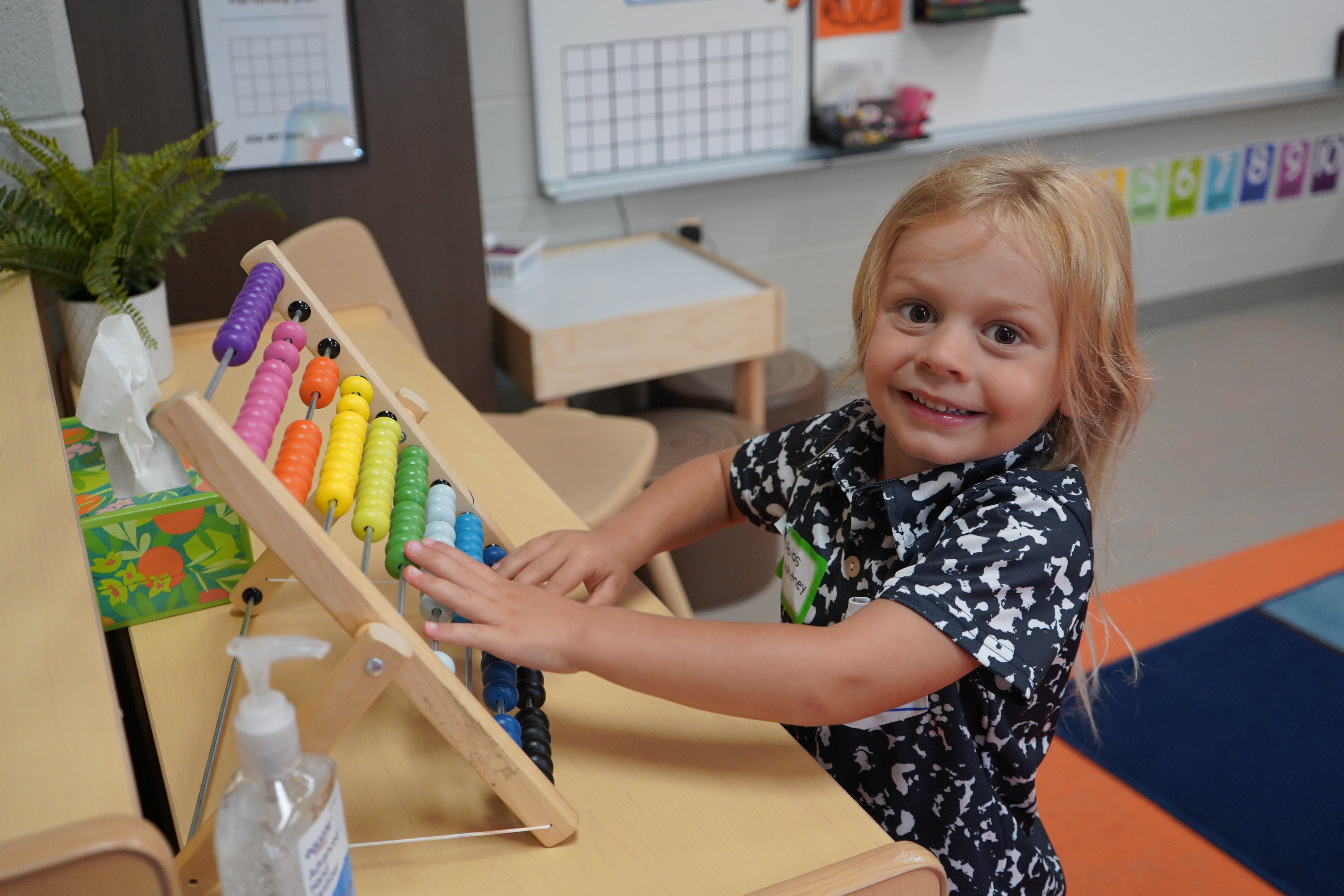 Student playing with counter toy