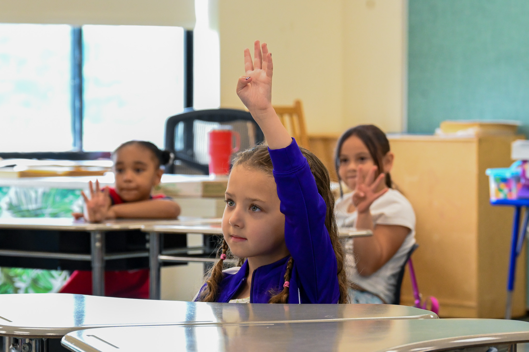 A student raises her hand