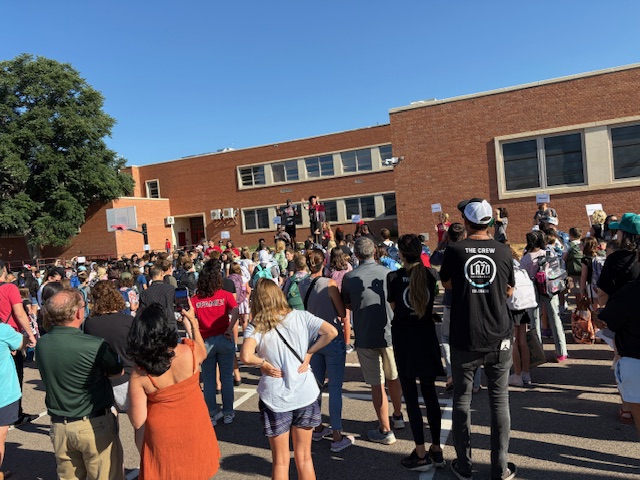 families gathered outside on the first day of school 