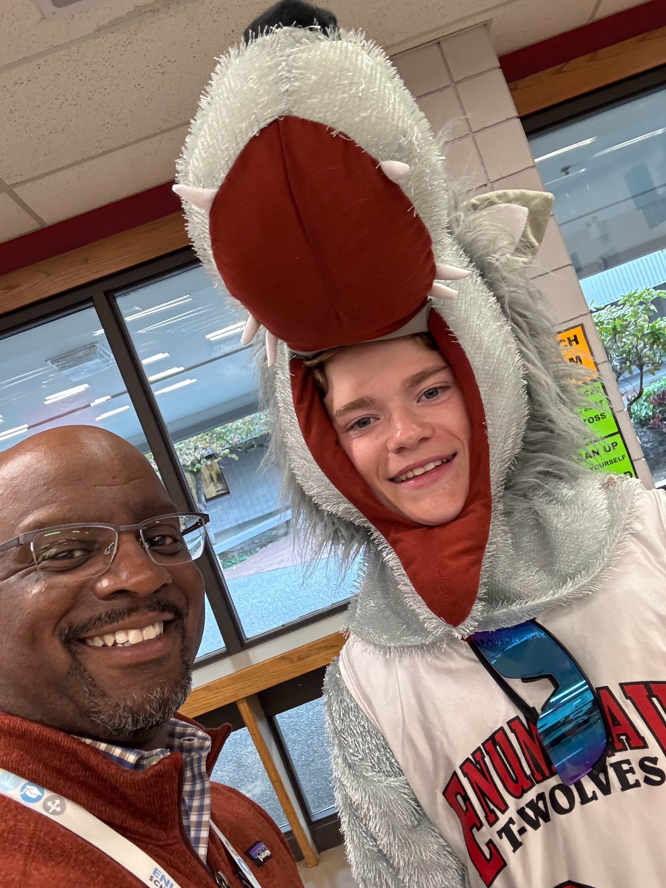 Dr. Carey taking a selfie with the EMS Timberwolf mascot at the EMS Open House