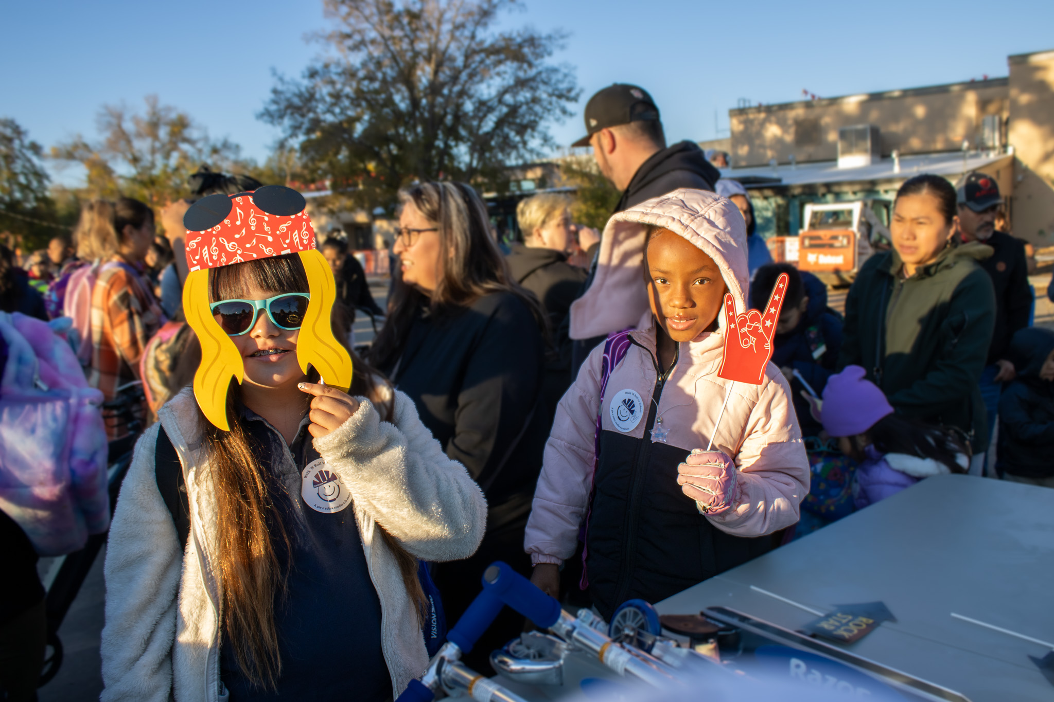 Two students pose with props at Walk N Roll to School Day. 