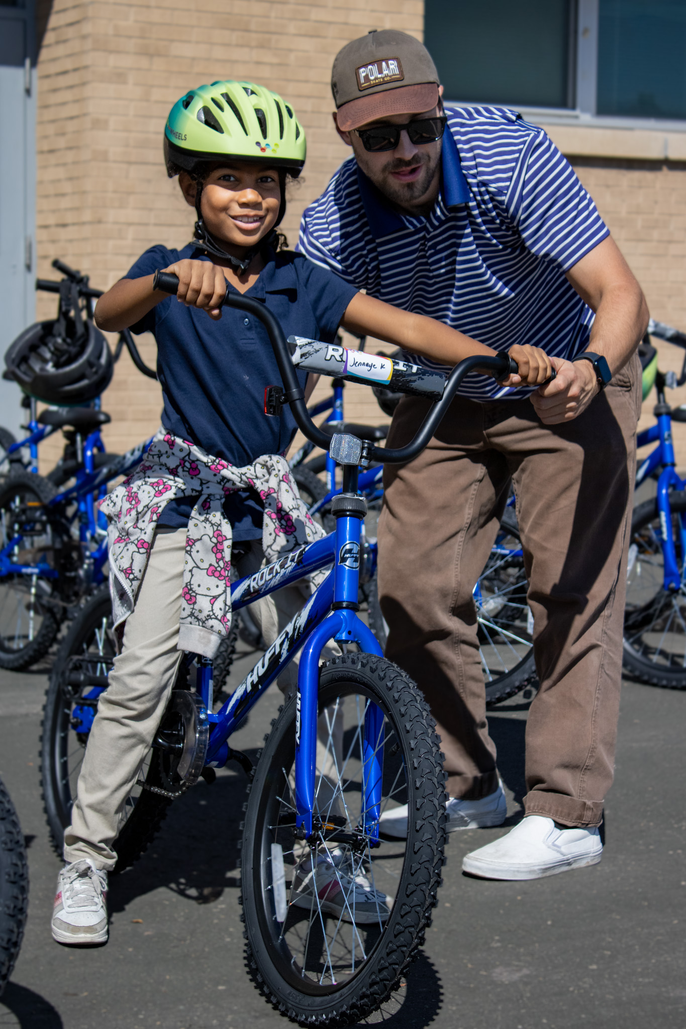 A student poses for a photo on her new bike.