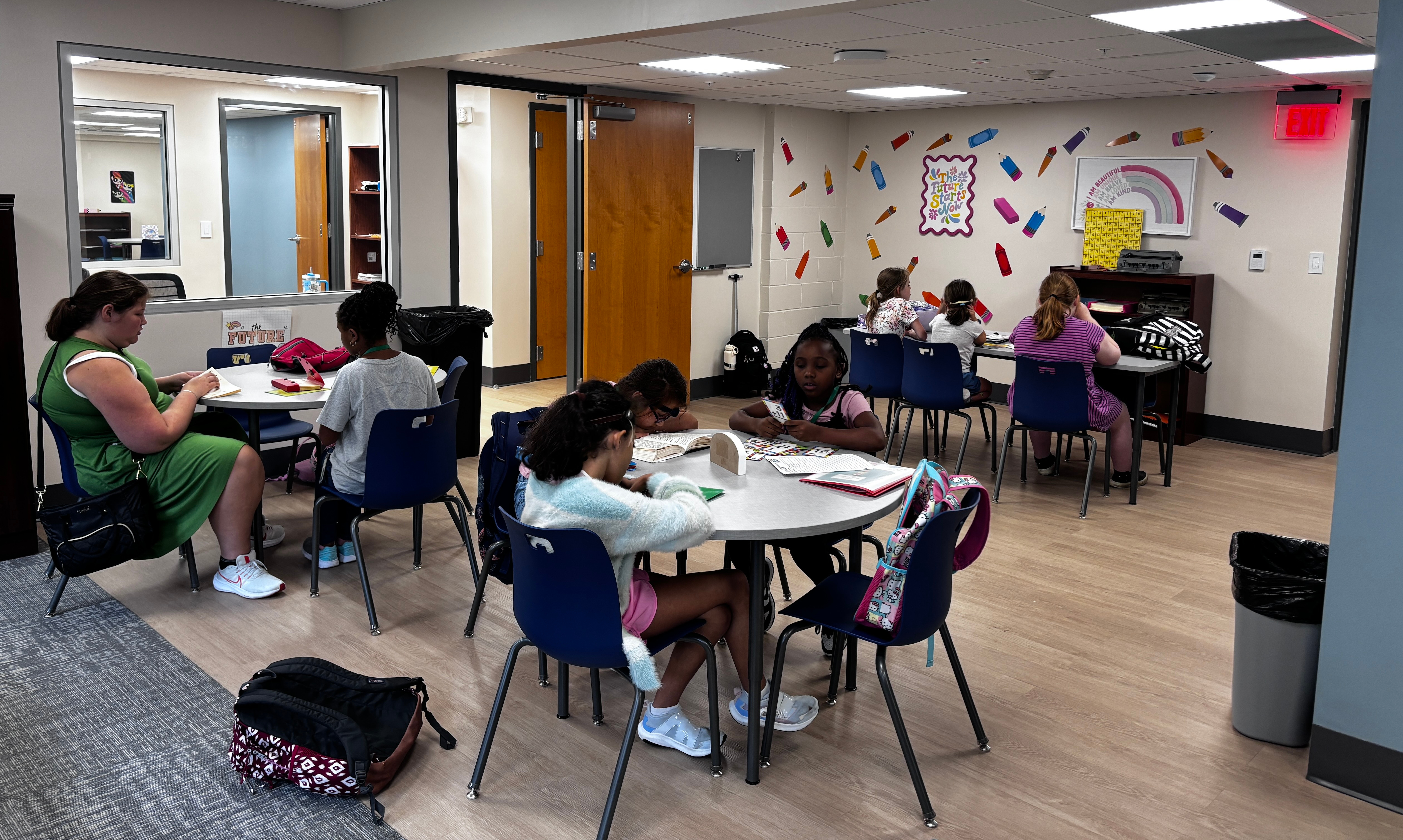 students sitting at tables doing homework
