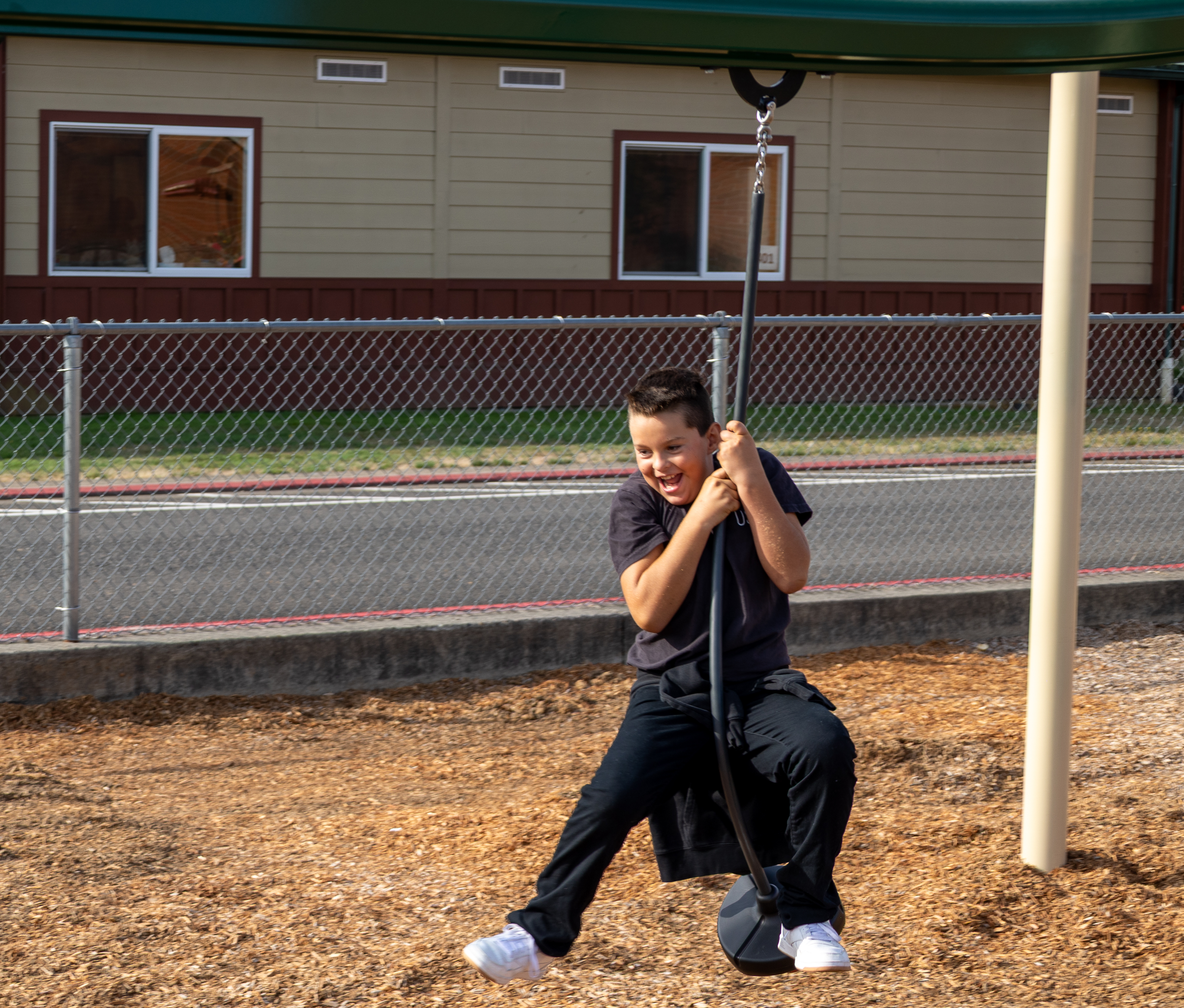 A student enjoys the new playground at their school